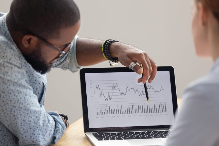 stock-photo-focused-african-analyst-showing-client-or-colleague-annual-financial-report-analyzing-business-data-1368244205