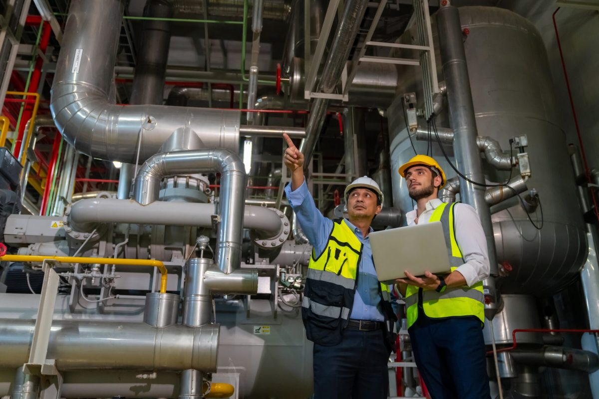 stock-photo-professional-male-electrical-engineer-in-safety-uniform-working-and-discussion-at-factory-site-2422033785