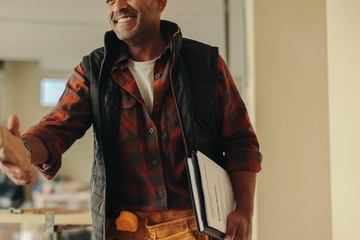 stock-photo-building-contractor-shaking-hands-with-a-homeowner-indoors-happy-with-agreement-on-the-renovation-2437288289