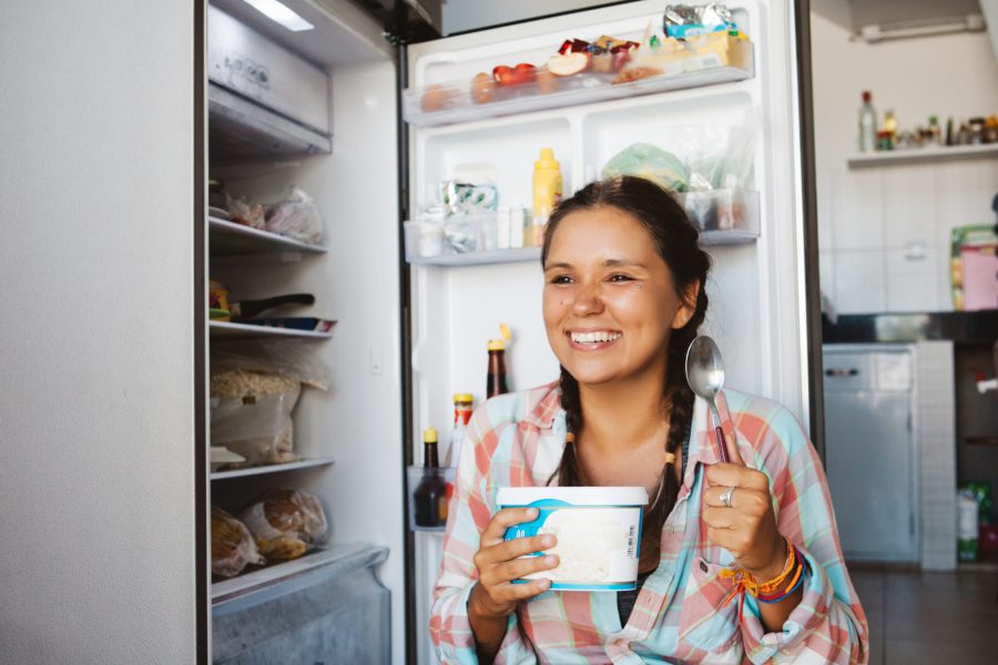 Young,Woman,Sitting,Next,To,The,Fridge,,Trying,To,Keep