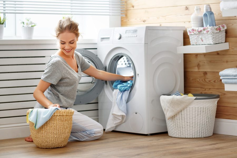 stock-photo-a-happy-housewife-woman-in-laundry-room-with-washing-machine-793737499