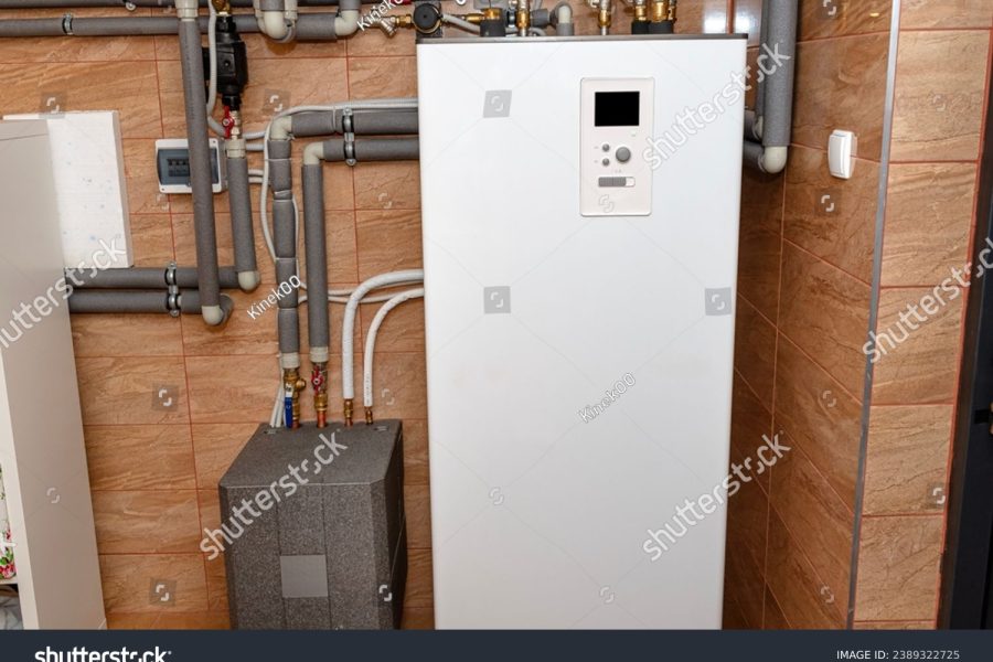 stock-photo-a-modern-air-heat-pump-installed-in-the-home-s-boiler-room-visible-plastic-pipes-and-valves-2389322725