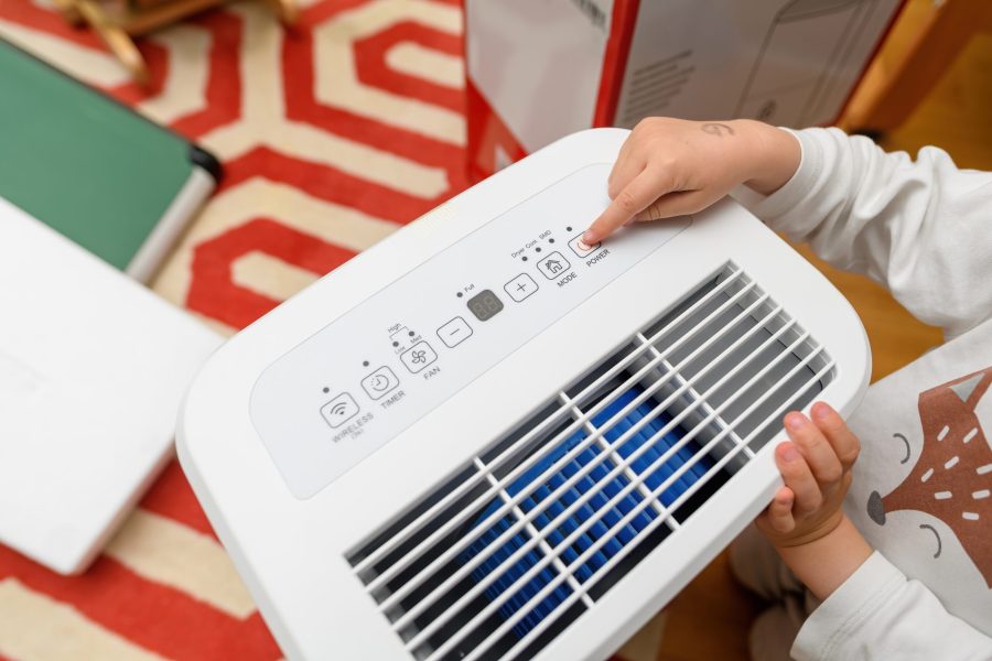 stock-photo-a-toddler-s-hand-pointing-to-the-button-of-a-wi-fi-home-dehumidifier-preparing-for-the-wet-season-2496181869