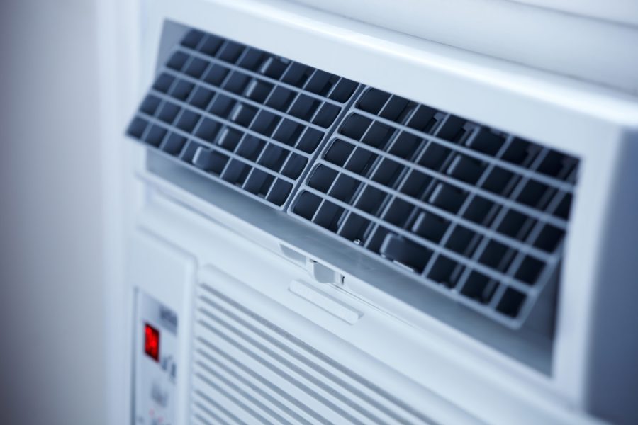 stock-photo-a-window-air-conditioner-focusing-on-the-air-vents-1279577440