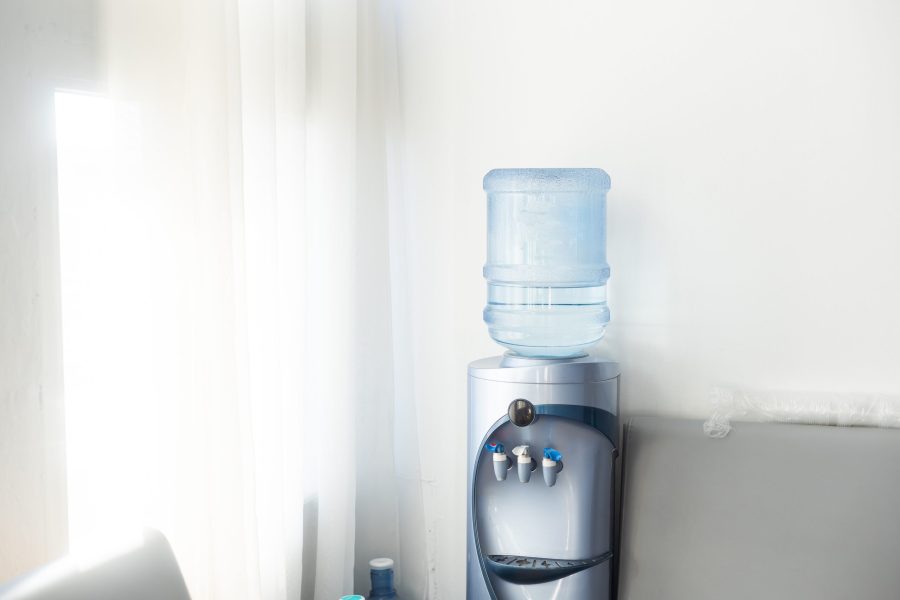 stock-photo-blue-water-gallon-on-water-cooler-in-office-2459453315