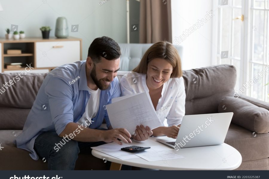 stock-photo-cheerful-young-millennial-husband-and-wife-doing-domestic-paperwork-accounting-job-reviewing-2203225387