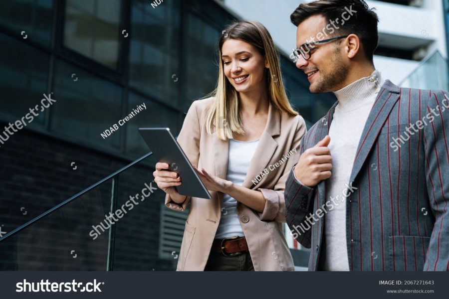 stock-photo-two-creative-business-people-working-on-social-media-strategy-using-a-digital-tablet-2067271643-1