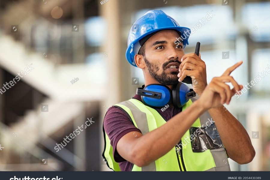 stock-photo-young-mixed-race-supervisor-instructing-workers-using-walkie-talkie-at-construction-site-2054430389